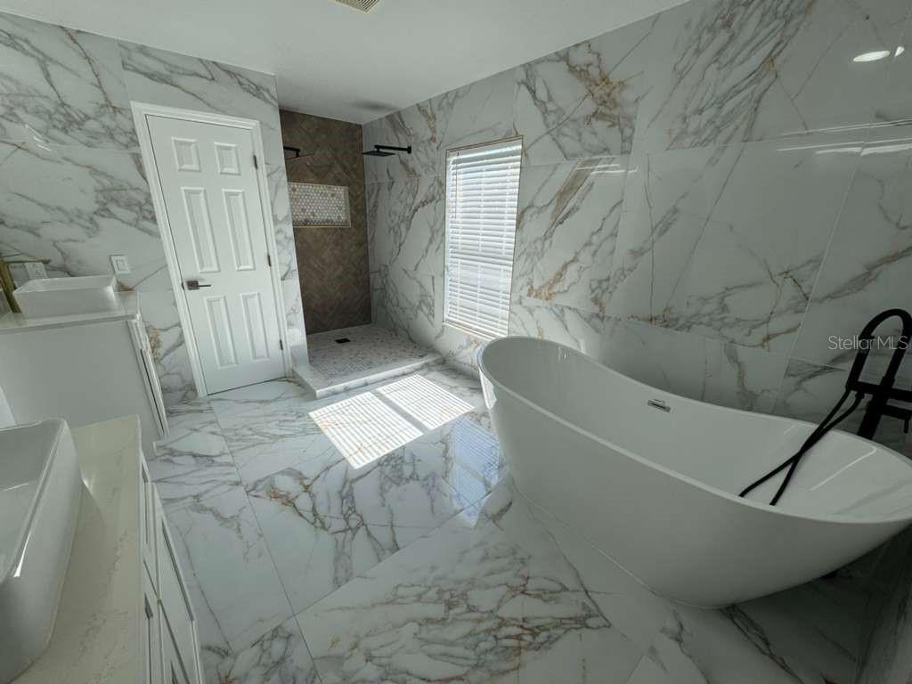 2579 Hunley Loop Kissimmee, FL 34743 - Photo 4 of 35 a bathroom with a bathtub and toilet