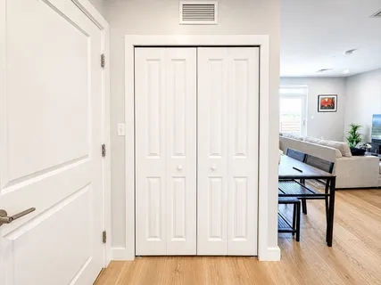 a view of a hallway with wooden floor and furniture