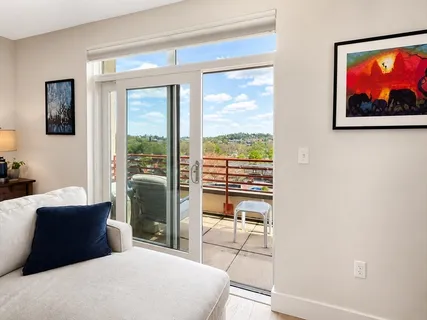 a bedroom with a large bed and a view of chair