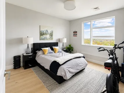a bedroom with a bed window and a table