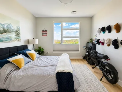 a bedroom with a bed and a window