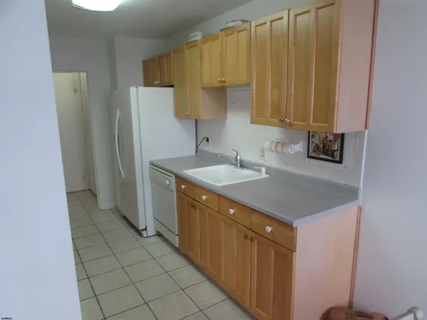 a kitchen with a sink a refrigerator a washer and dryer