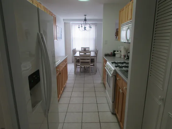 a kitchen with stainless steel appliances granite countertop a refrigerator a stove a sink and dishwasher