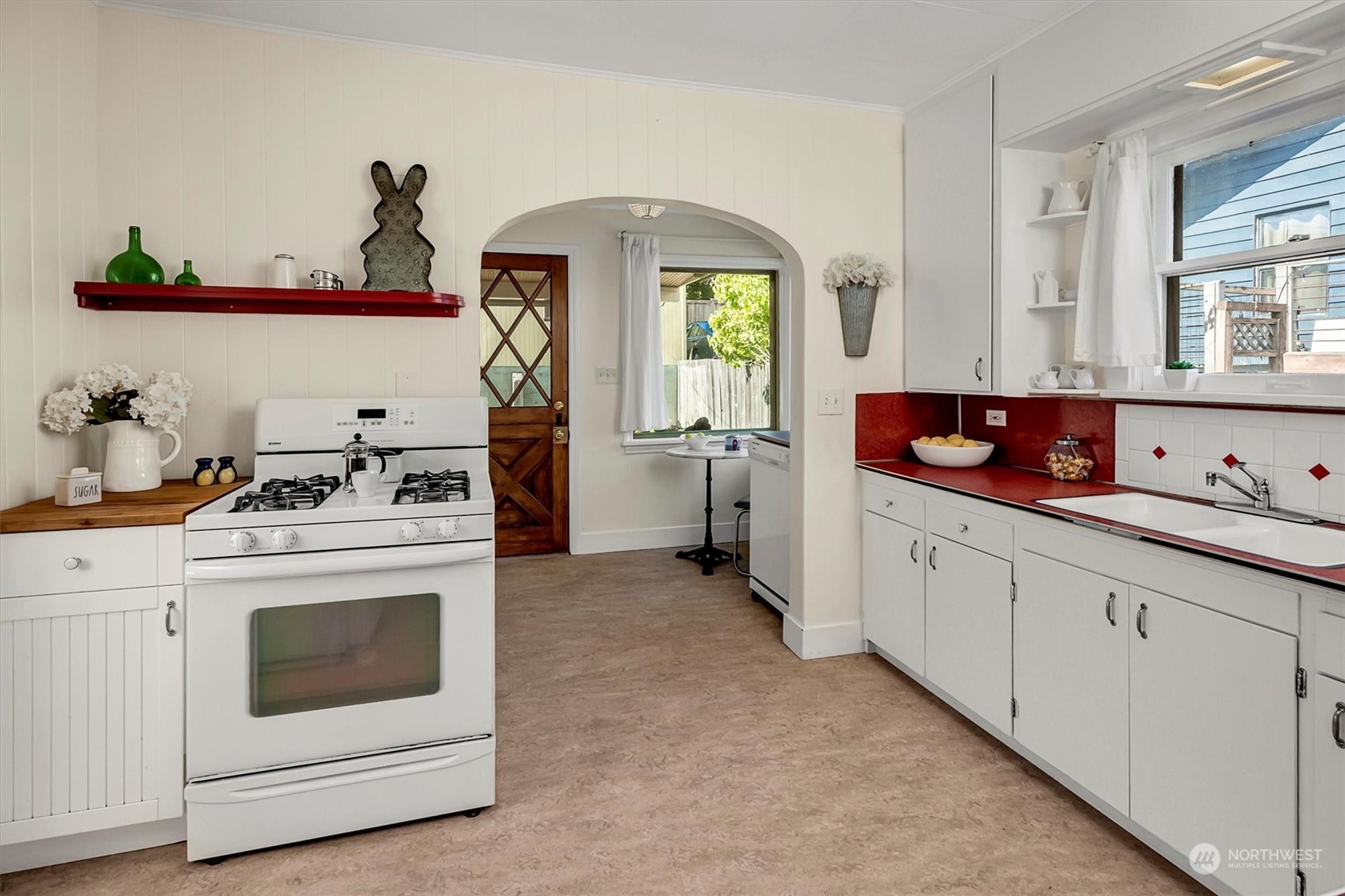 5051 40th Avenue Southwest Seattle, WA 98136 - Photo 13 of 40 a kitchen with white cabinets and white appliances