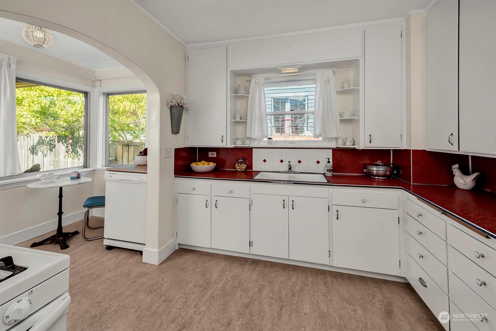 5051 40th Avenue Southwest Seattle, WA 98136 - Photo 14 of 40 a kitchen with white cabinets and window