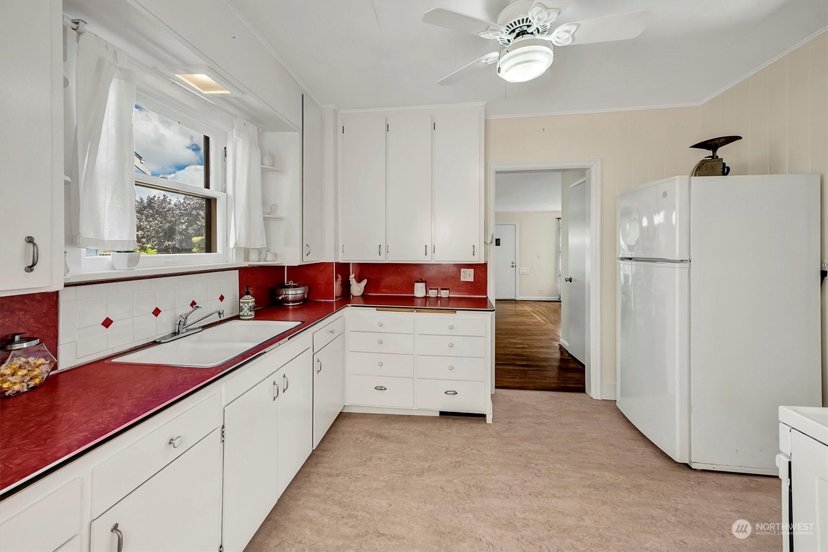 5051 40th Avenue Southwest Seattle, WA 98136 - Photo 15 of 40 a kitchen with a refrigerator and a sink
