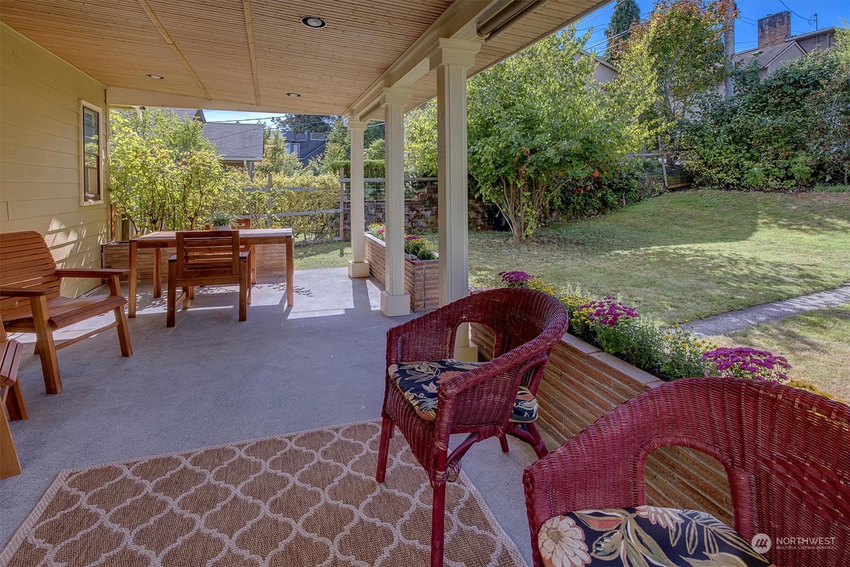 5051 40th Avenue Southwest Seattle, WA 98136 - Photo 20 of 40 a view of a patio with a table chairs and a backyard