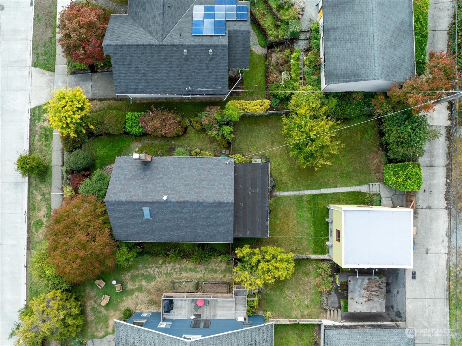 5051 40th Avenue Southwest Seattle, WA 98136 - Photo 36 of 40 an aerial view of a house with a yard and garden