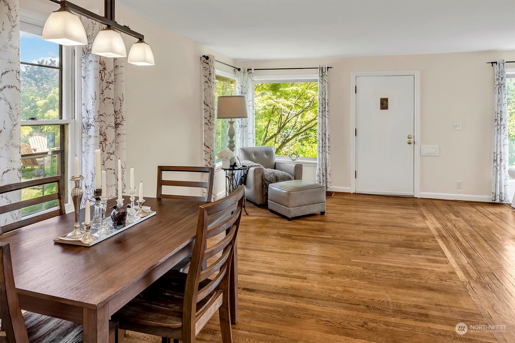 5051 40th Avenue Southwest Seattle, WA 98136 - Photo 9 of 40 a view of a dining room with furniture a chandelier and wooden floor
