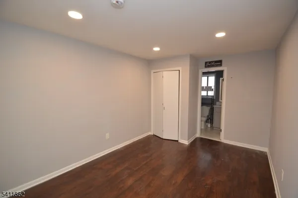 a view of hallway with wooden floor