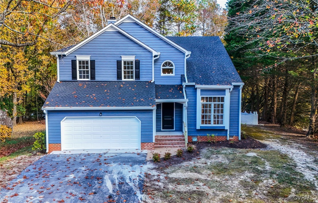 14900 Sandstone Ridge Court Midlothian, VA 23112 - Photo 1 of 50 a front view of a house with a yard and garage