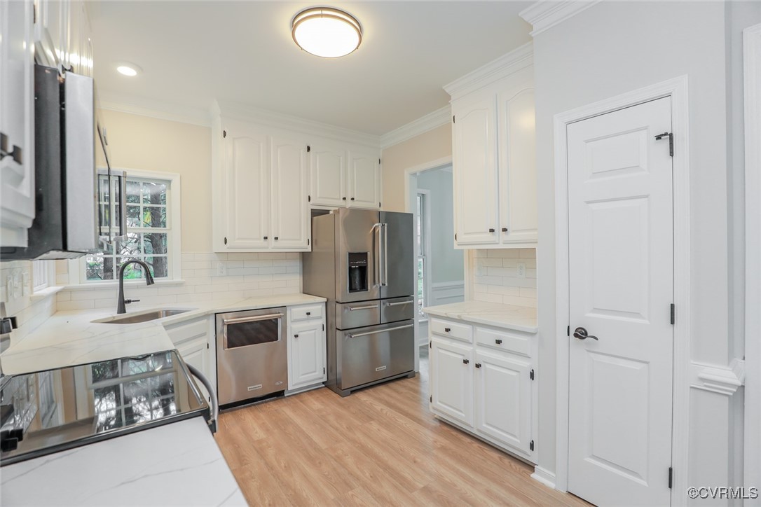 14900 Sandstone Ridge Court Midlothian, VA 23112 - Photo 13 of 50 a kitchen with white cabinets and stainless steel appliances