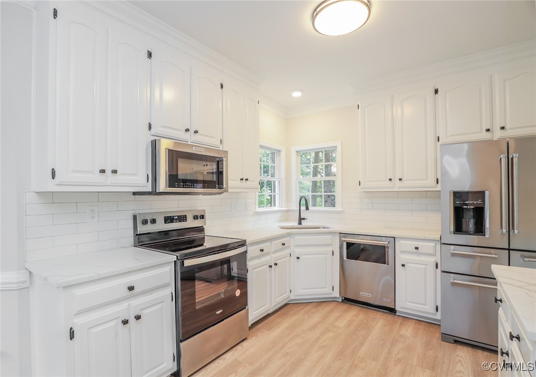 14900 Sandstone Ridge Court Midlothian, VA 23112 - Photo 15 of 50 a kitchen with cabinets stainless steel appliances a sink and wooden floor