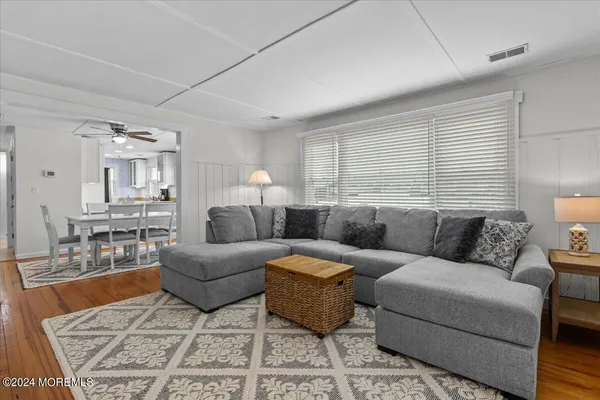 a bedroom with two beds and painting on the wall