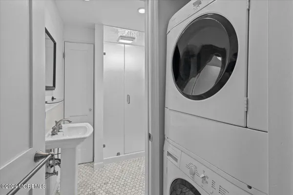 a bathroom with a sink a washer and dryer