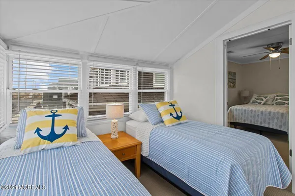 a bedroom with 2 bed and a couch