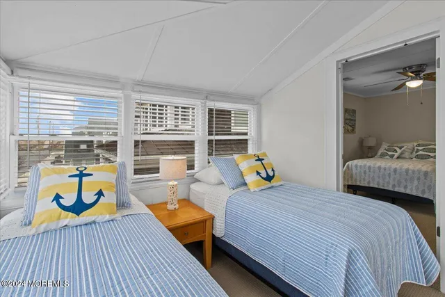 a bedroom with 2 bed and a couch