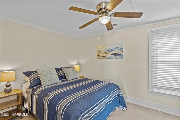 a bedroom with bed and a window