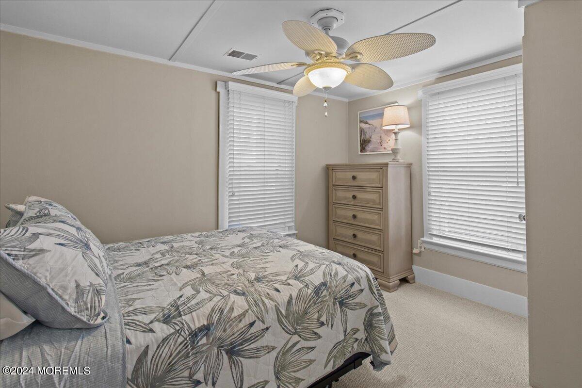 51 3rd Avenue Lavallette, NJ 08735 - Photo 24 of 36 a bedroom with a bed and a chandelier