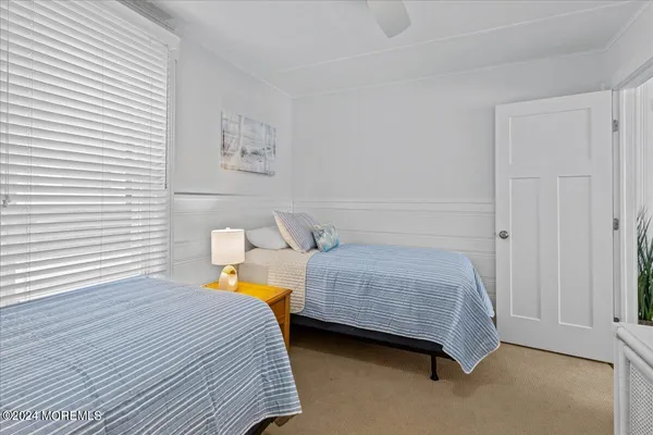 a bedroom with two beds and painted walls