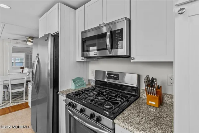 a kitchen with stainless steel appliances granite countertop a stove and a refrigerator