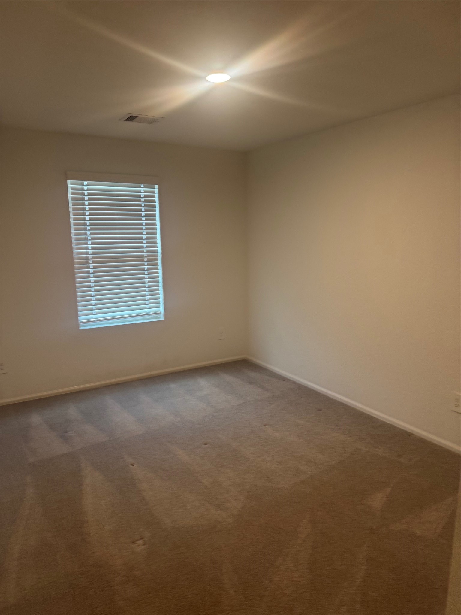 3202 Holly Stokes Way Conroe, TX 77301 - Photo 23 of 24 an empty room with a window