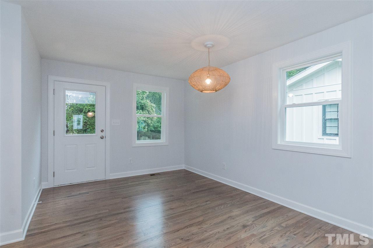 915 Elm Street Raleigh, NC 27604 - Photo 12 of 25 an empty room with wooden floor and windows