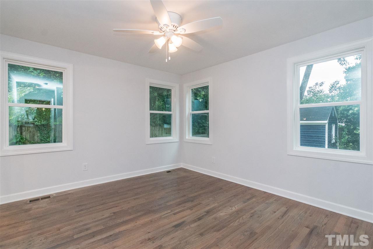 915 Elm Street Raleigh, NC 27604 - Photo 14 of 25 a view of an empty room with wooden floor and a window