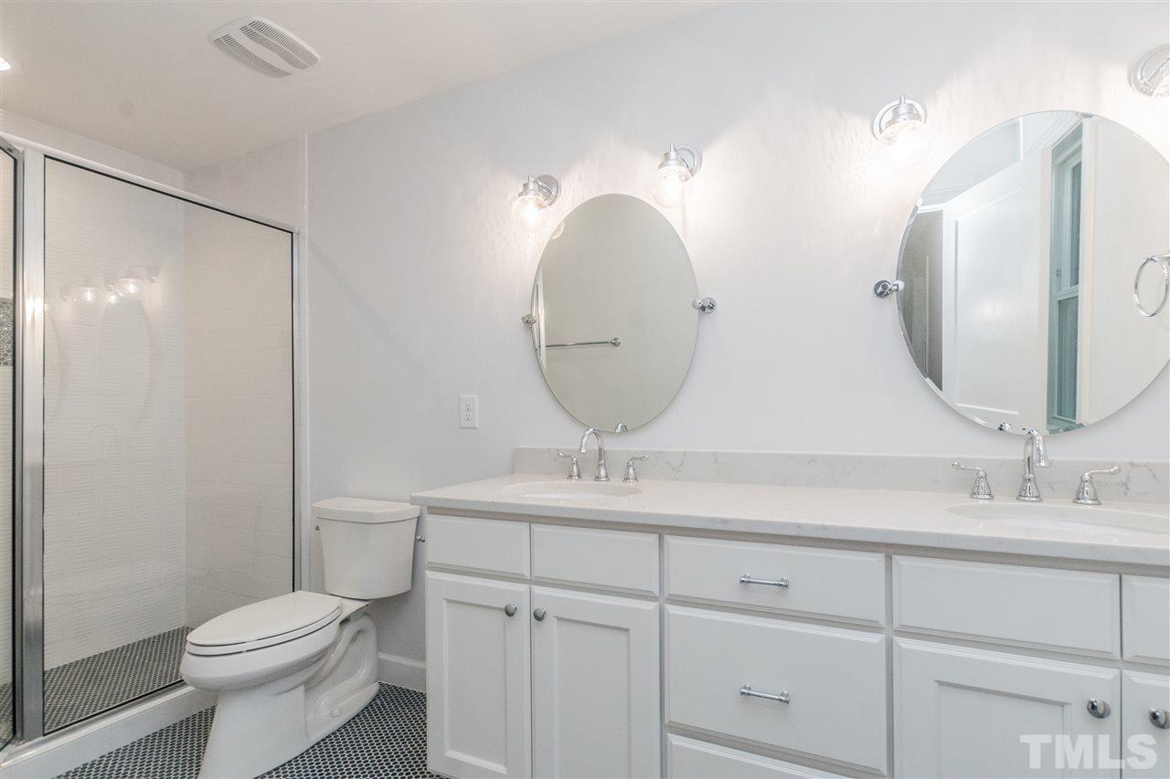 915 Elm Street Raleigh, NC 27604 - Photo 17 of 25 a bathroom with a toilet sink and mirror