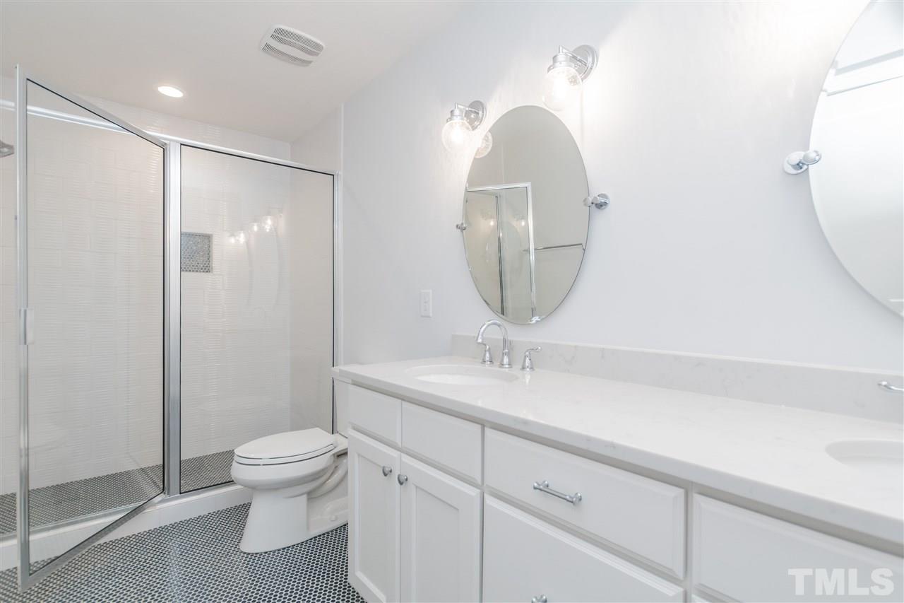 915 Elm Street Raleigh, NC 27604 - Photo 18 of 25 a bathroom with a toilet a sink and mirror