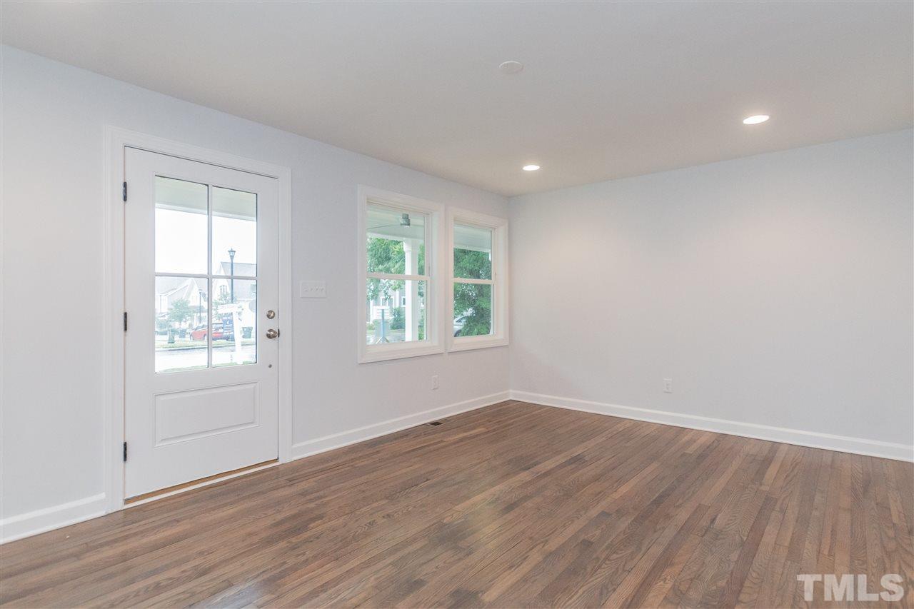 915 Elm Street Raleigh, NC 27604 - Photo 4 of 25 an empty room with wooden floor and windows