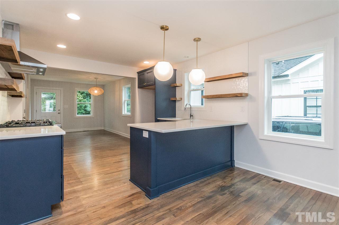 915 Elm Street Raleigh, NC 27604 - Photo 8 of 25 a kitchen with a refrigerator and a wooden floor