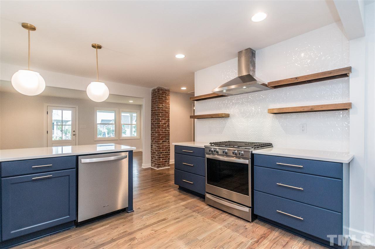 915 Elm Street Raleigh, NC 27604 - Photo 10 of 25 a kitchen with stainless steel appliances granite countertop a stove and cabinets