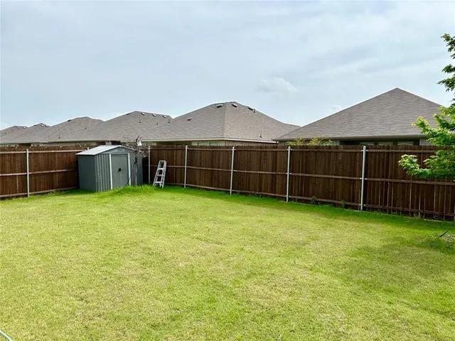 a view of a house with a backyard and a garden