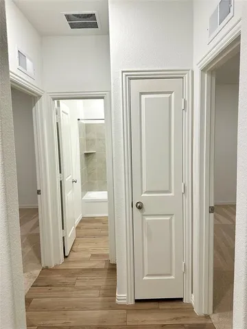 a view of a bathroom from a hallway