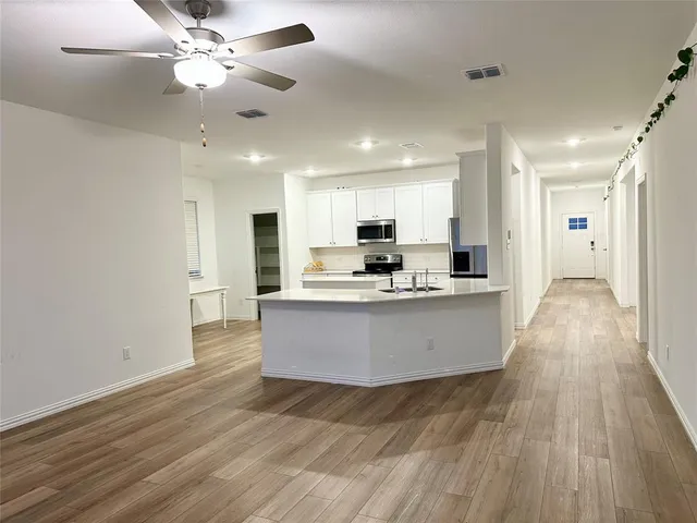 a large kitchen with kitchen island a island in the center