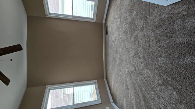 a view of an empty room with a window