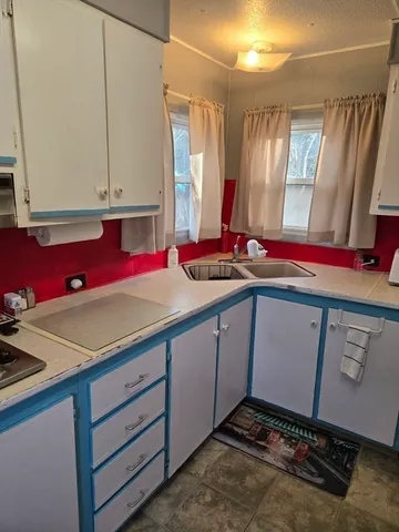 a kitchen with a refrigerator stove and cabinets