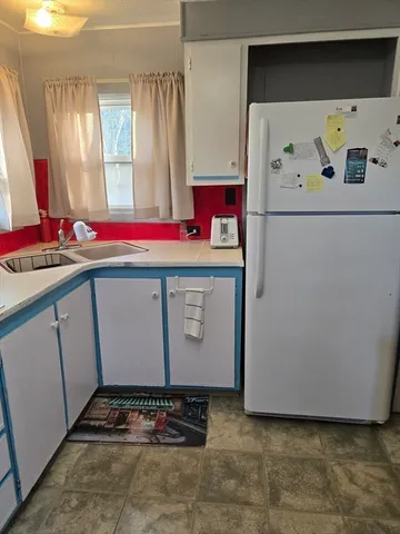 a room with a table and a chandelier