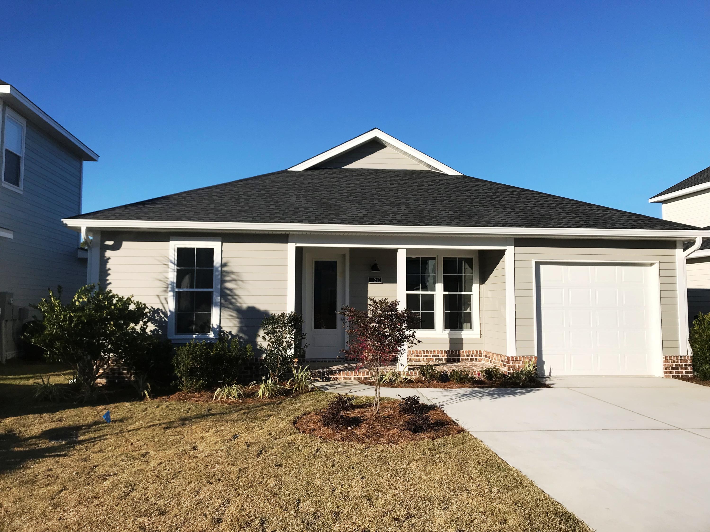 213 Chapman Street Santa Rosa Beach, FL 32459 - Photo 1 of 30 a front view of a house with a yard outdoor seating and garage