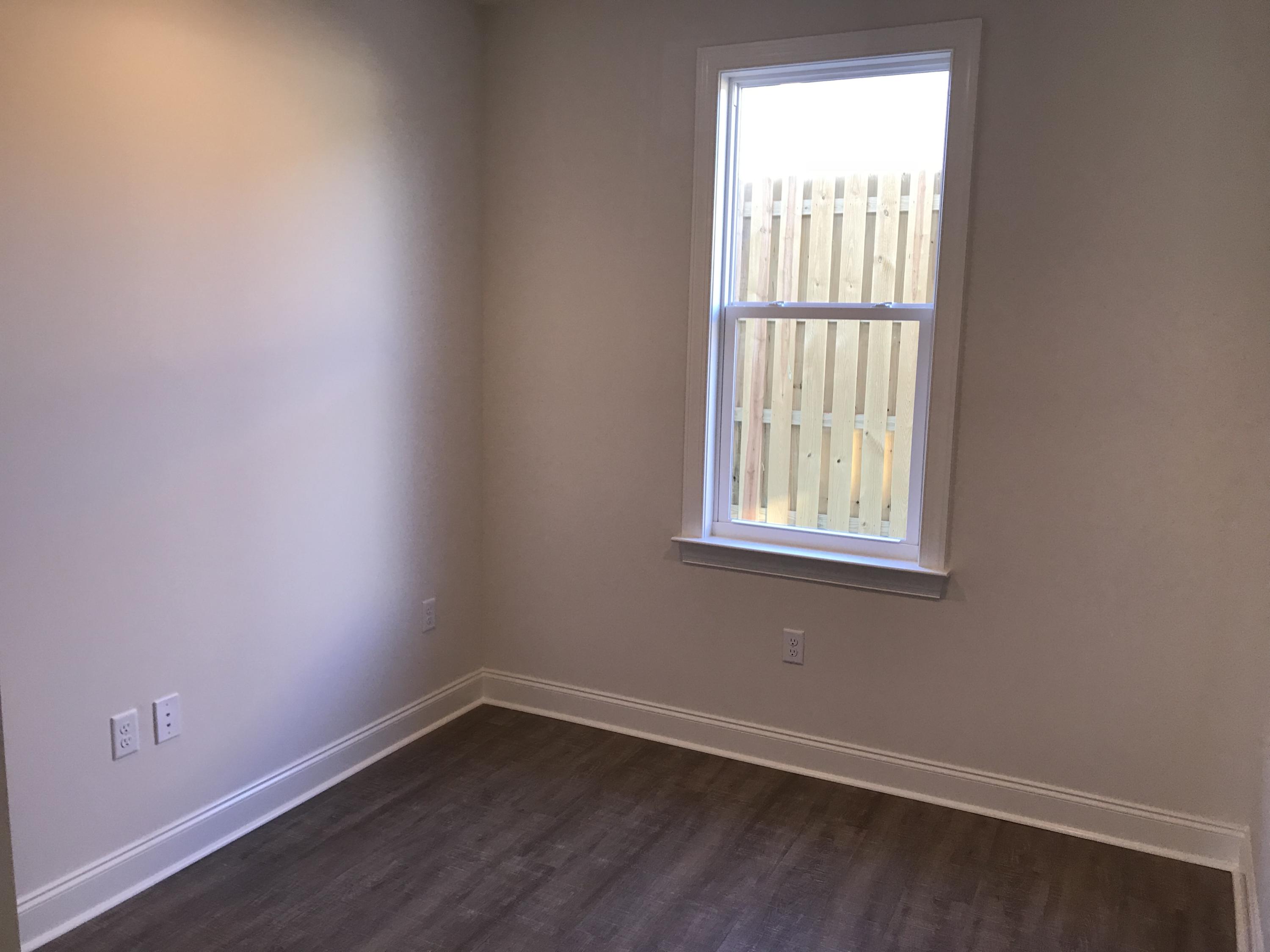 213 Chapman Street Santa Rosa Beach, FL 32459 - Photo 18 of 30 an empty room with wooden floor and windows