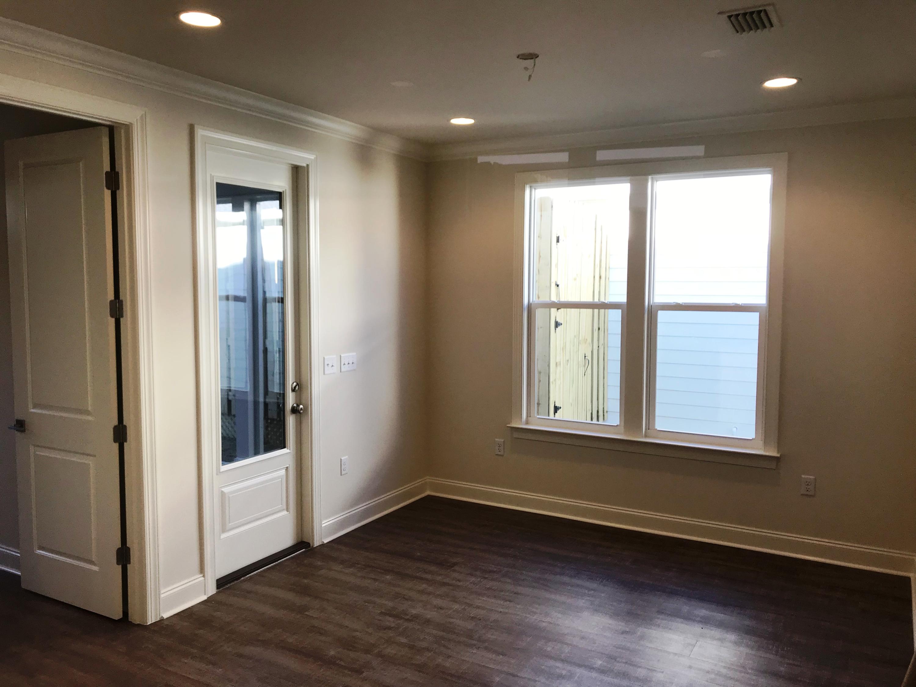 213 Chapman Street Santa Rosa Beach, FL 32459 - Photo 8 of 30 a view of an empty room with wooden floor and a window