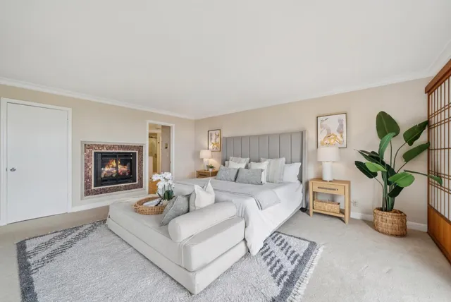 a bedroom with bed and a large window