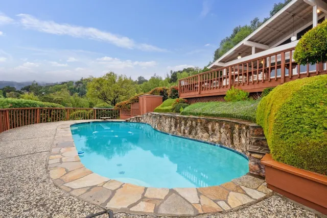 en empty room with a large window and chandelier