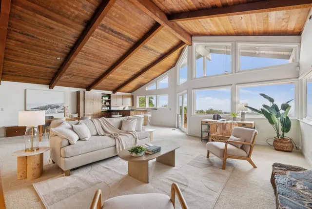 a living room with furniture a fireplace and a chandelier