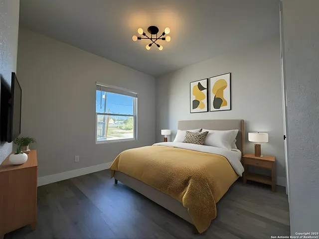 a view of an empty room and wooden floor cabinet