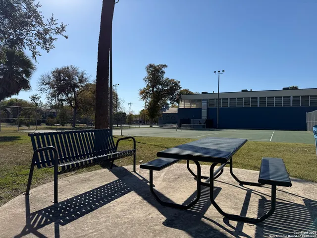 a view of a yard with furniture and trees