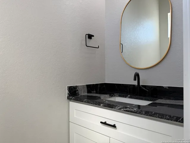 a bathroom with a sink and a mirror