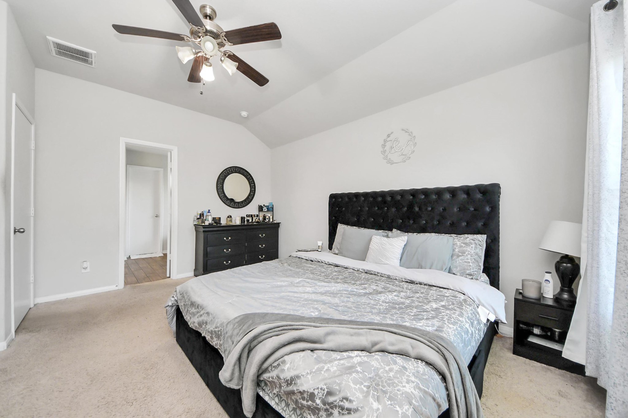 2643 Ridgeback Drive Rosenberg, TX 77471 - Photo 24 of 46 a bedroom with a bed and a chandelier