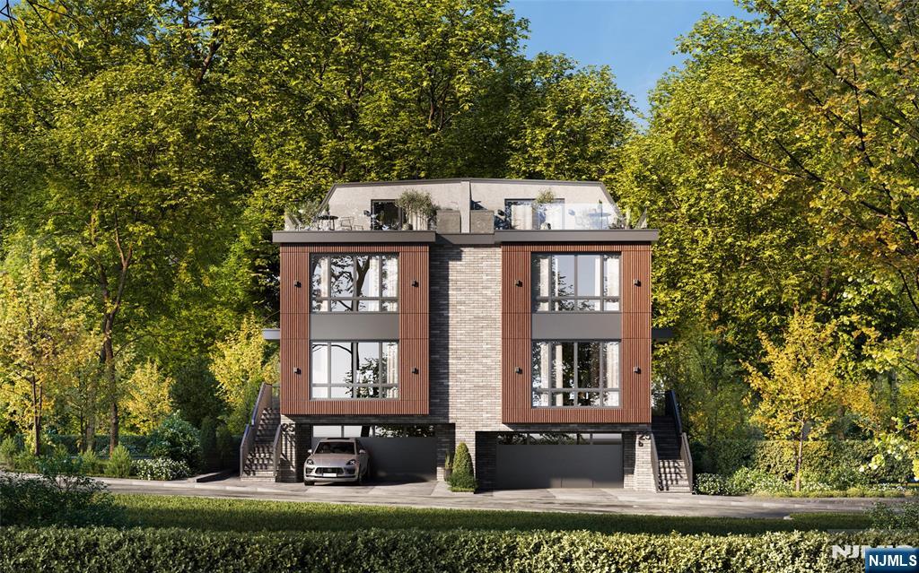 25 Garden Place, Unit B Edgewater, NJ 07020 - Photo 3 of 4 a front view of a residential apartment building with a yard